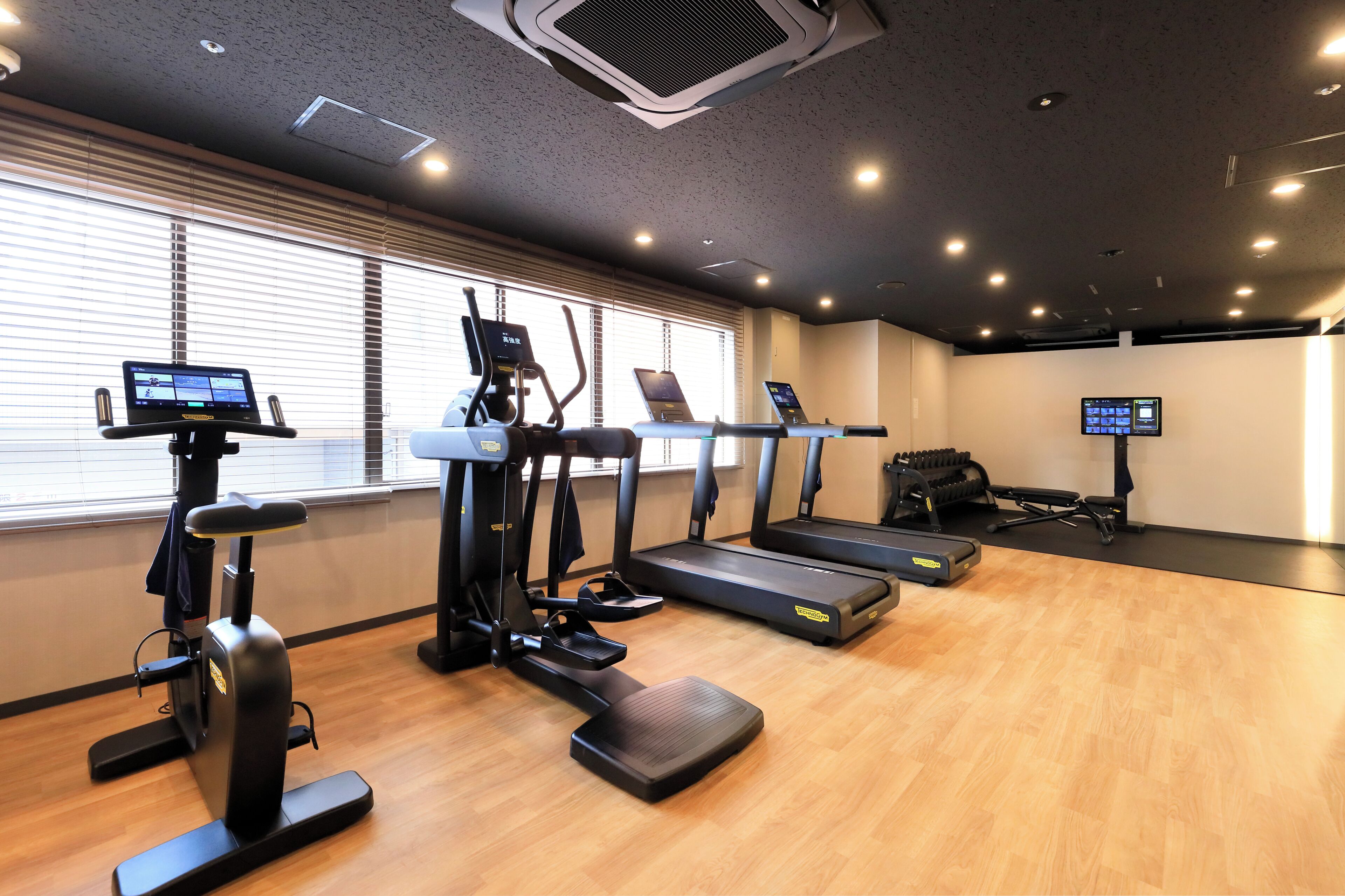 A gym with treadmills, elliptical machines, and a rowing machine.