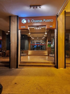 De ingang van Hotel El Oumnia Puerto, met een duidelijke trap die naar binnen leidt.