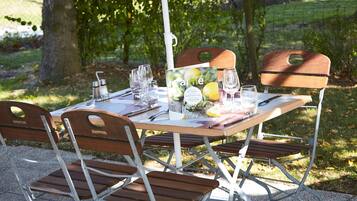 A table set outdoors with chairs, a menu, and a bottle of water.