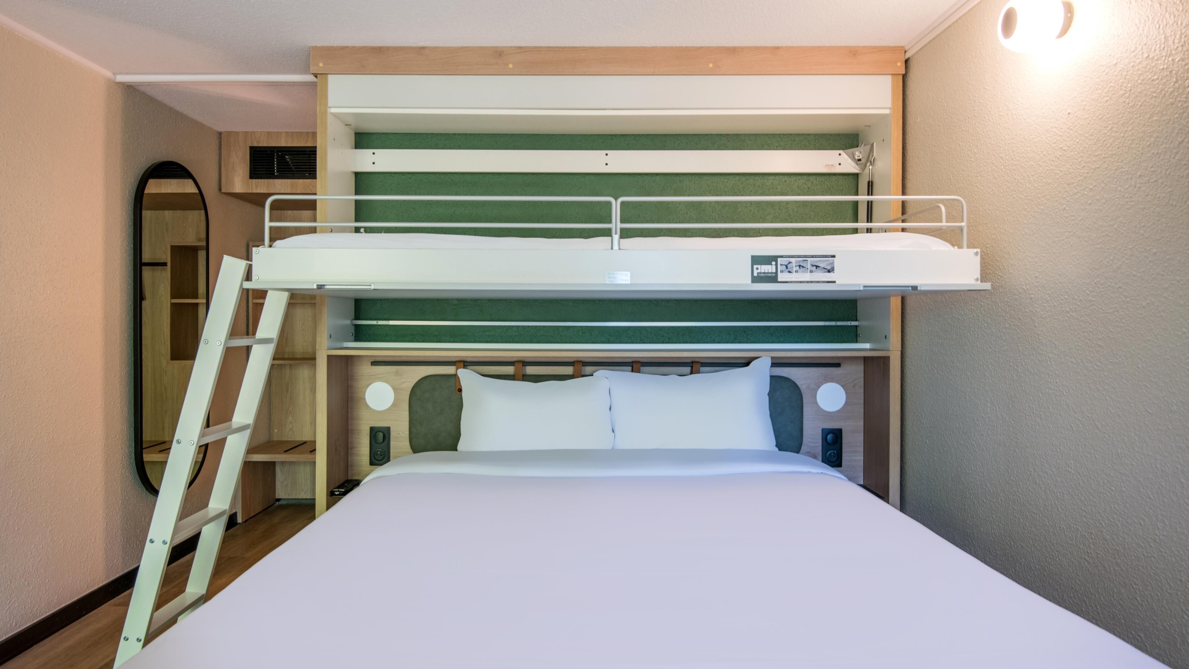 A bunk bed with a ladder, a control panel, and a green headboard.