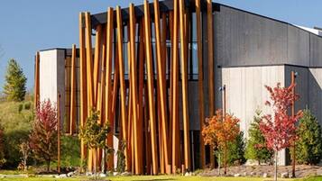 A modern building with vertical wooden slats and large windows.