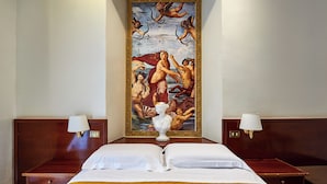 A hotel room with a large classical painting on the wall, a bed with white linens, and two bedside tables with lamps. - Virginia Hotel (Rome)