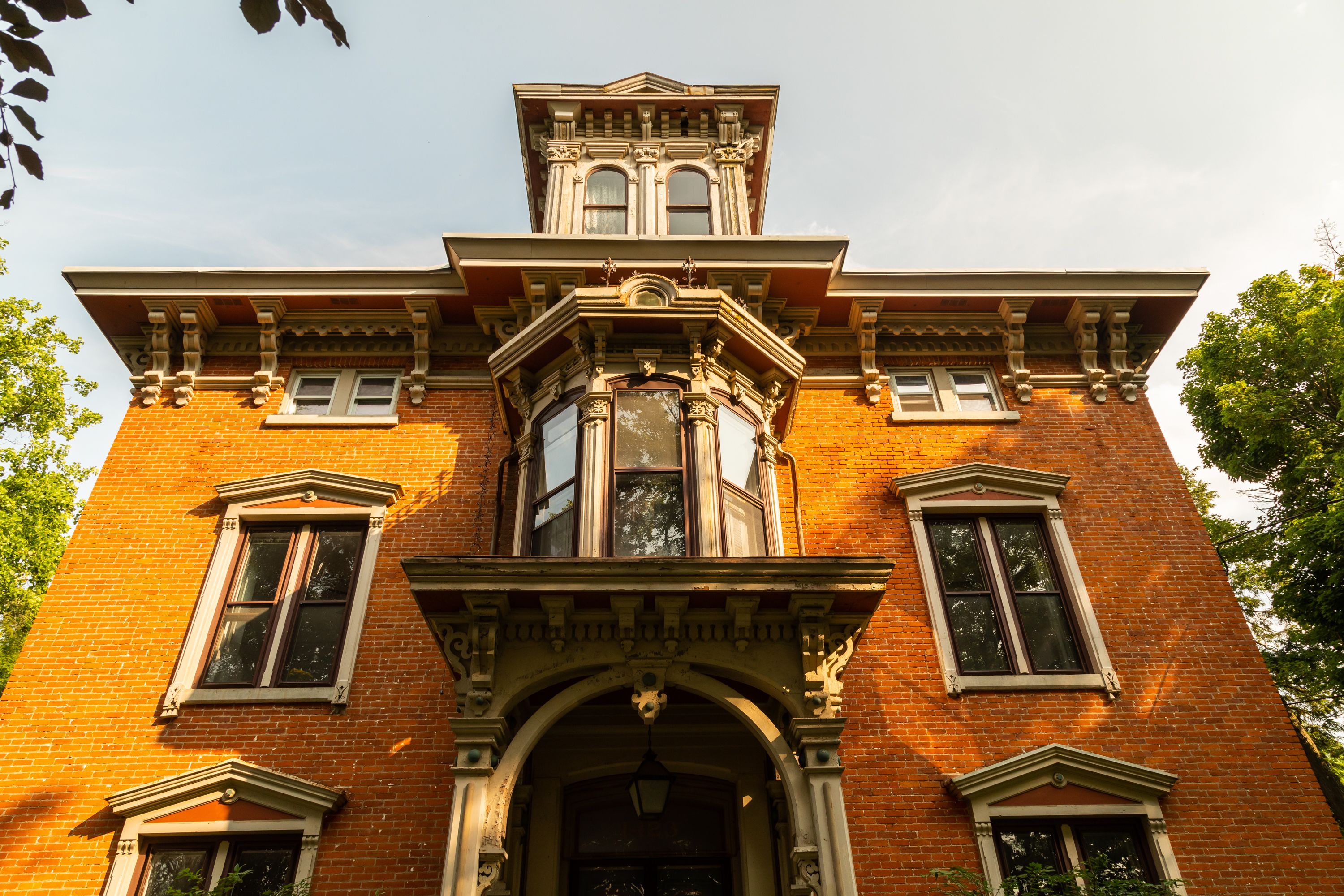 A historic building with a prominent central tower, large windows, and detailed architectural elements.
