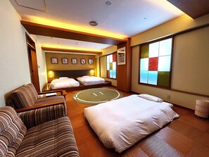 A hotel room with a bed, two sofas, a round rug, and a large window with a view. - Pearl Hotel Ryogoku (Tokyo)
