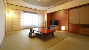 A traditional Japanese room with tatami flooring, a low table, sliding doors, and a television. - Karasuma Kyoto Hotel (Kyoto)