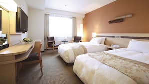 A hotel room with two beds, a desk, a chair, a TV, and a window with curtains. - Karasuma Kyoto Hotel (Kyoto)