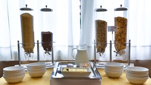 A breakfast buffet with various food items and a pitcher of milk. - Regal Hotel (Brescia)