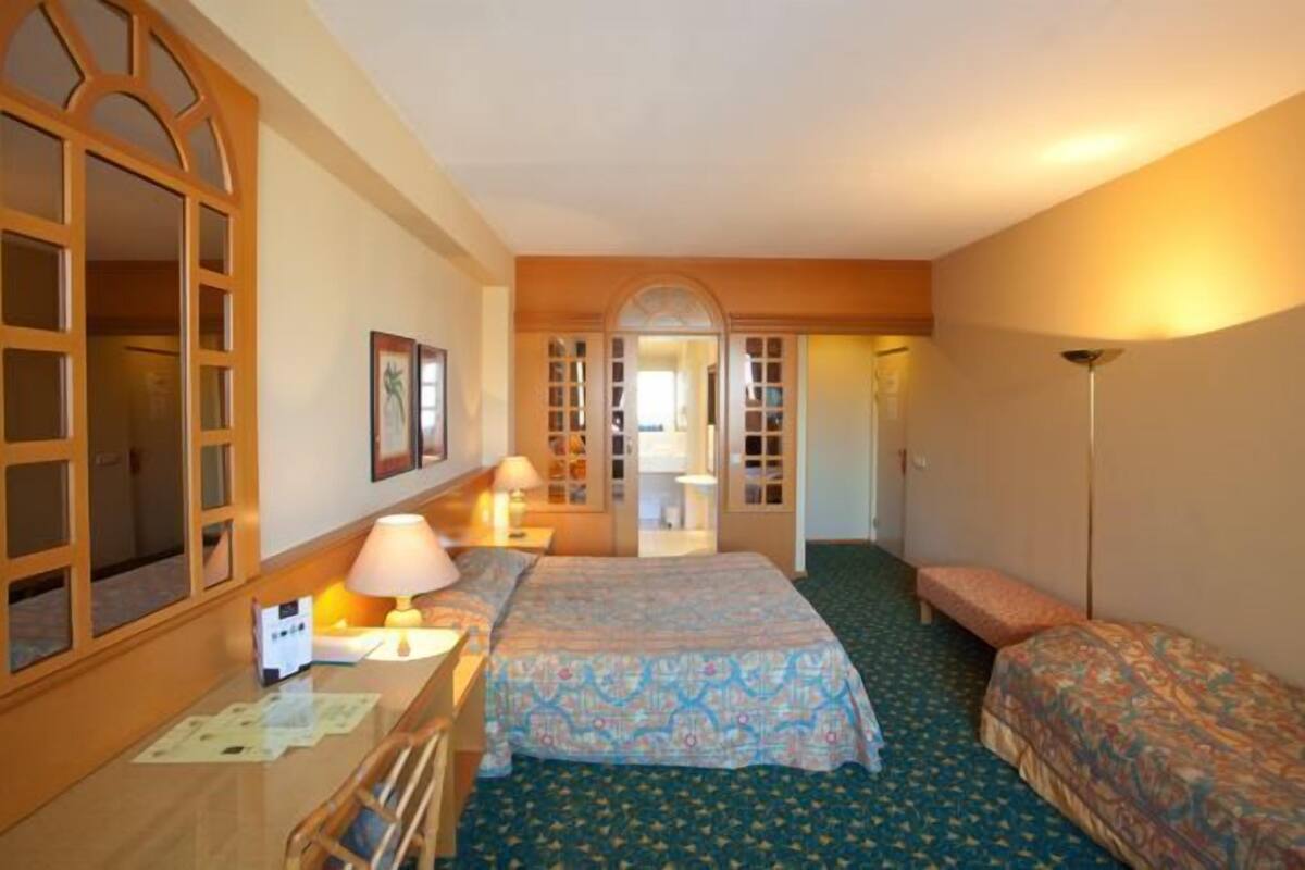 Triple Room | Minibar, blackout drapes, iron/ironing board (on request)