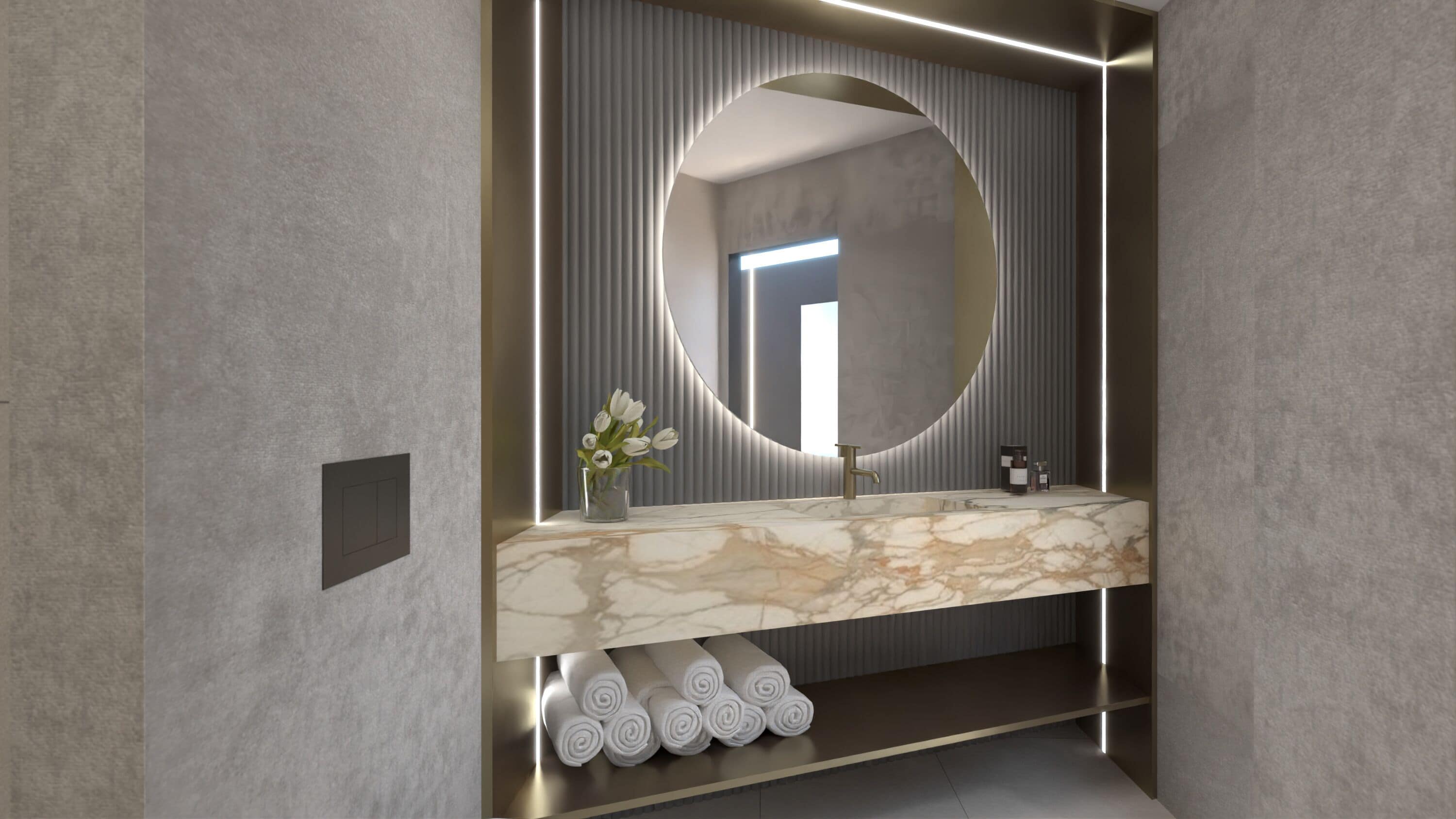 Un baño moderno con tocador de mármol, un espejo redondo grande y un perchero con toallas enrolladas ordenadamente.
