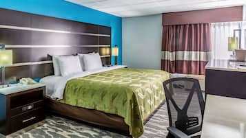 A hotel room with a bed, desk, chair, and a large window with curtains.