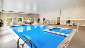 An indoor swimming pool with clear lanes, lounge chairs, and a 'Deep Water Diving' sign. - Sleep Inn & Suites Dunmore (Scranton)