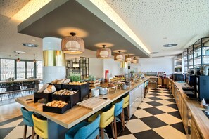 A modern kitchen with a central island, bar stools, and a checkered floor.