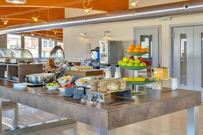 A buffet setup with various food items and condiments. - B&B Hotel Milano La Spezia (Milan)