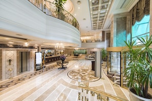 A spacious lobby with a grand staircase, a reception area, and a high ceiling with decorative elements. - Elite World Istanbul Taksim  (Istanbul)