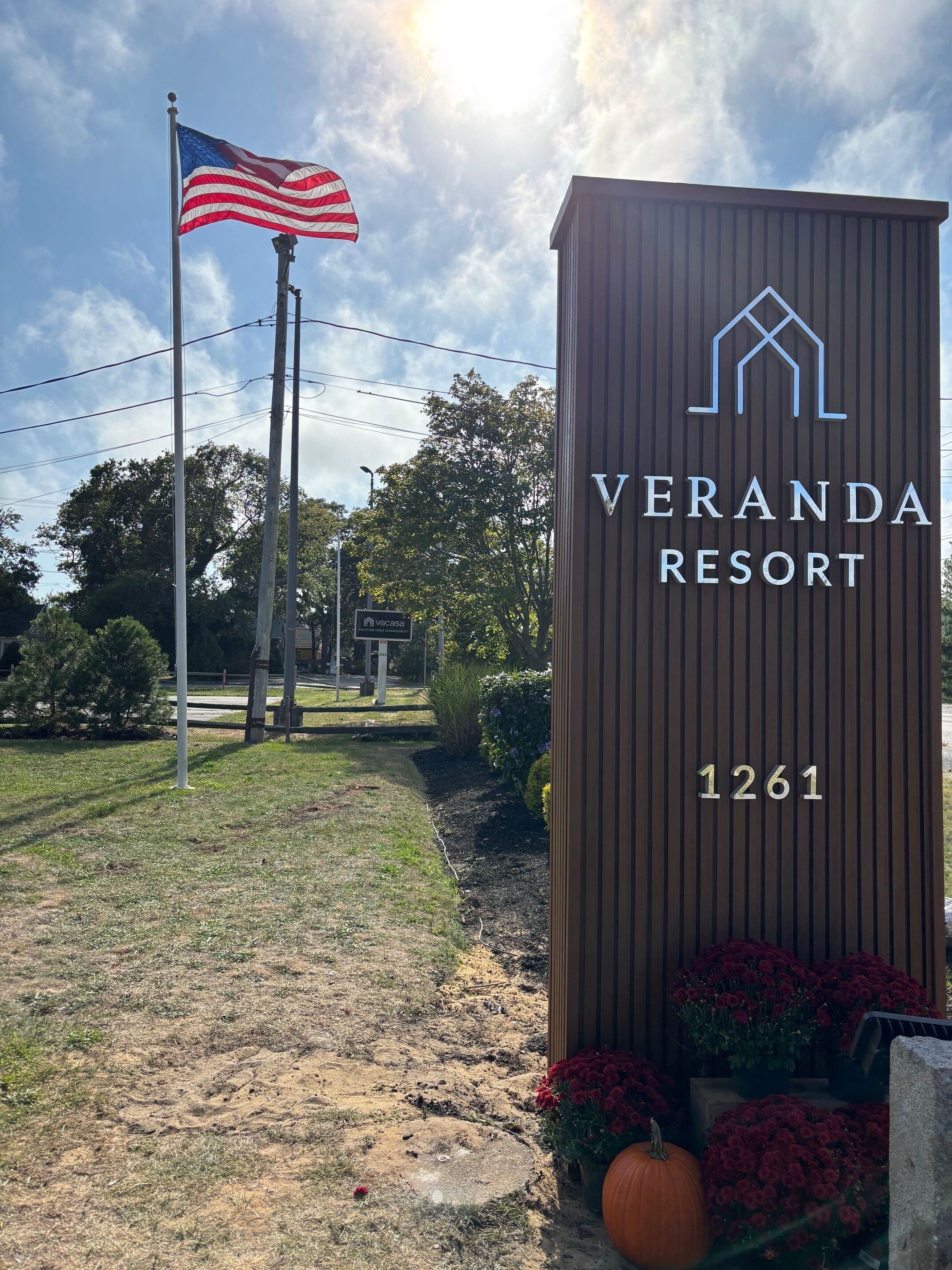 A sign for Veranda Resort with the number 1261, an American flag, and a Vercasa logo.