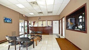 A reception area with a coffee machine, a reception desk, and several chairs. - Americas Best Value Inn Phillipsburg (Phillipsburg)