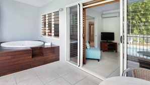 A bathroom with a large sink, wooden vanity, and a shower area. - Mantra Aqueous on Port (Port Douglas)