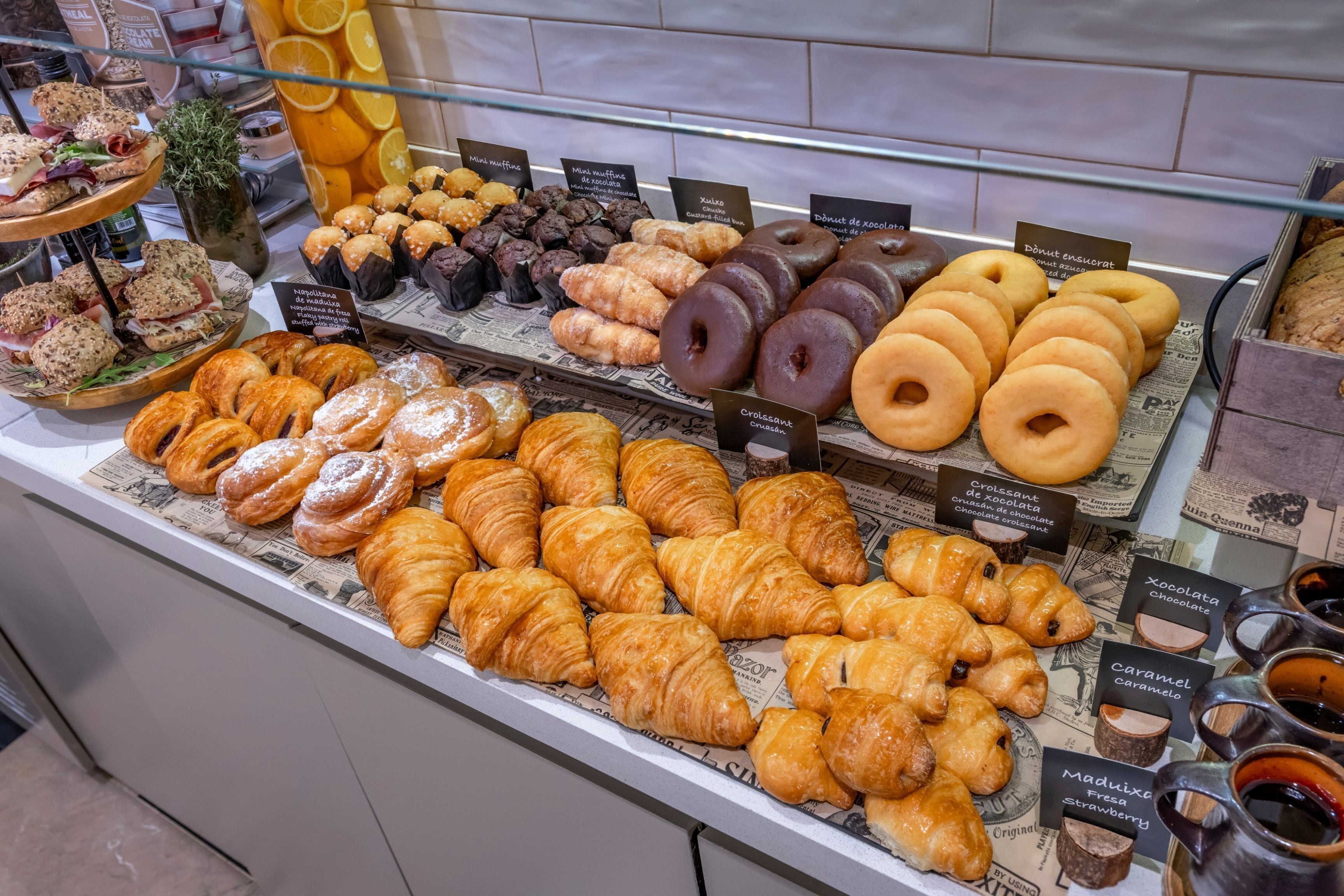 A bakery display with various pastries and doughnuts.