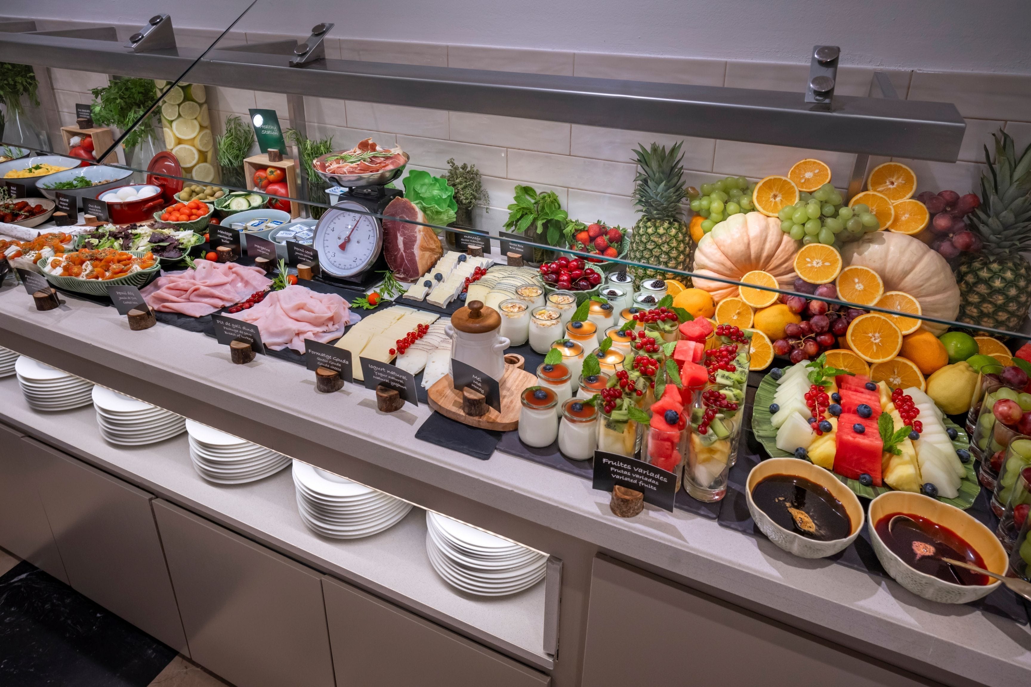 A buffet with various food items and a scale for weighing portions.