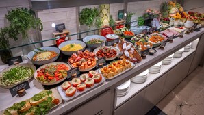 A buffet with various food items and a glass display case.