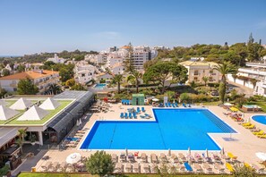 Relax by the pool surrounded by sun loungers and umbrellas, or enjoy refreshments in the shaded outdoor seating area.