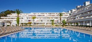 Relax by the large pool surrounded by sun loungers and umbrellas.
