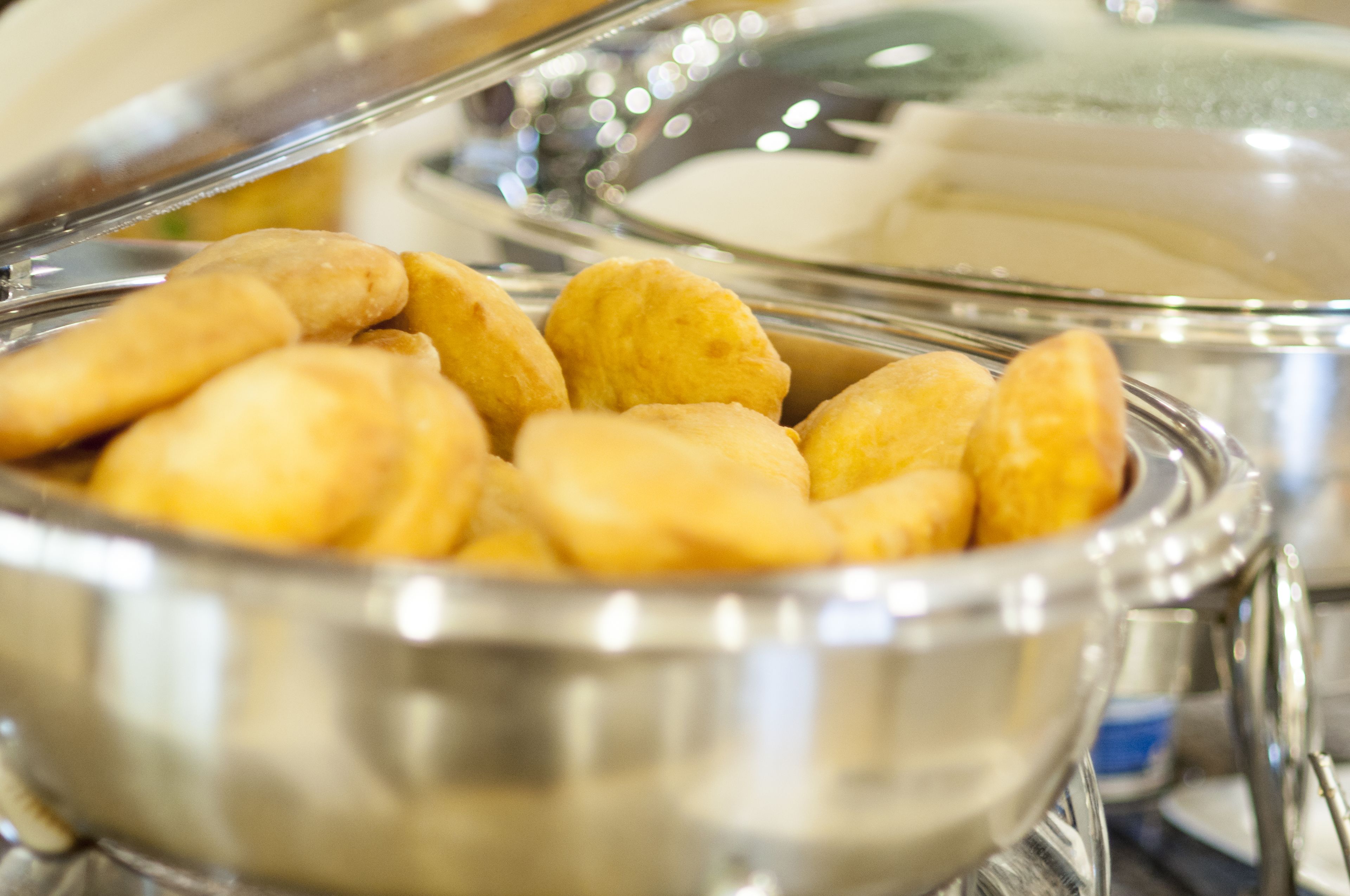 A buffet with a variety of food items, including what appears to be pastries and possibly other baked goods.
