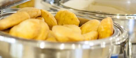 A buffet with a variety of food items, including what appears to be pastries and possibly other baked goods.