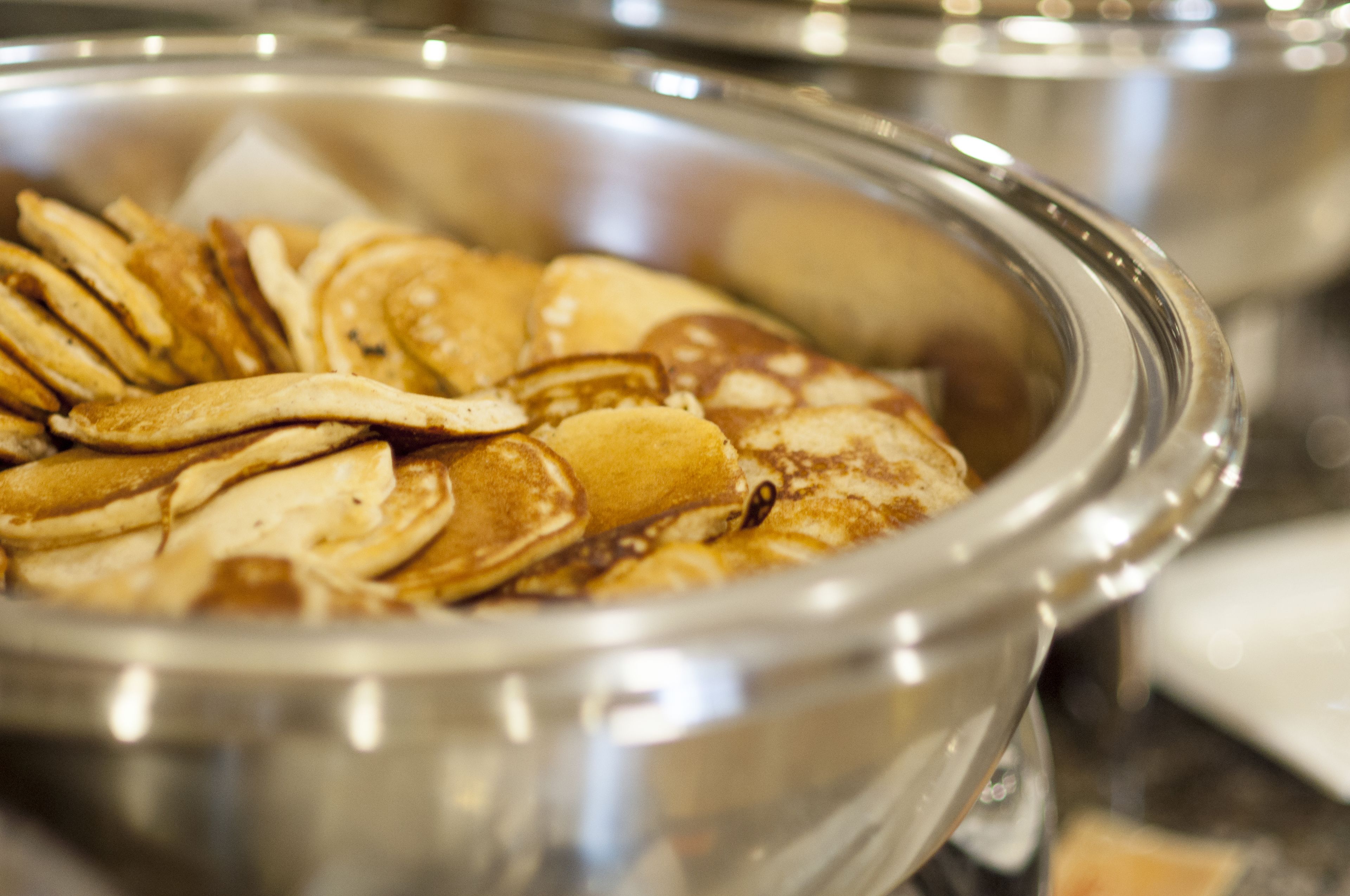 A buffet with pancakes and waffles.