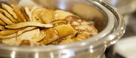 A buffet with pancakes and waffles.