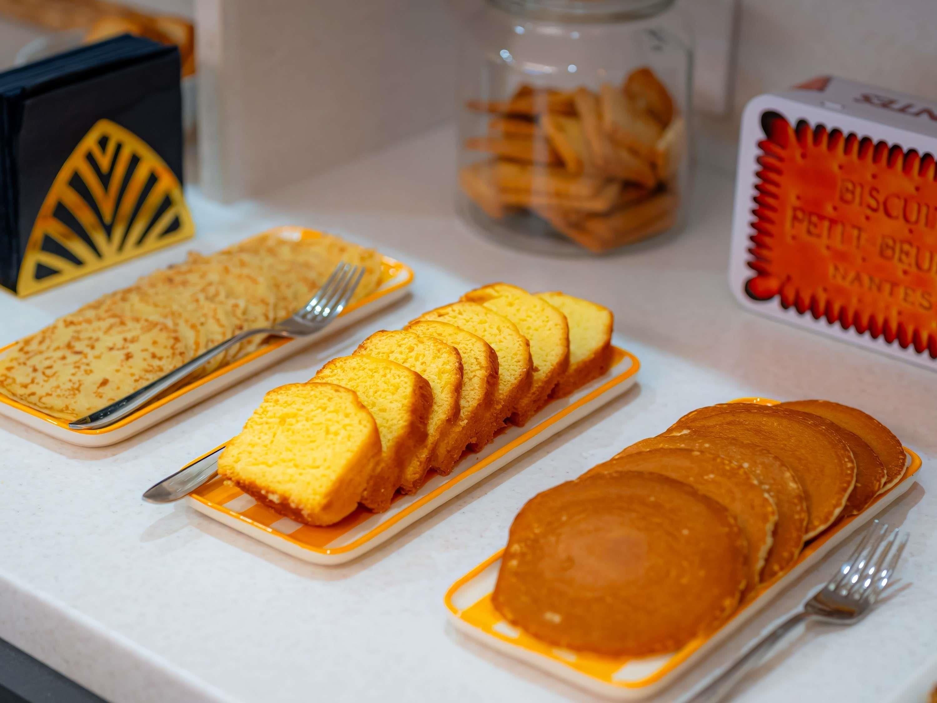 A breakfast buffet with various pastries and biscuits.