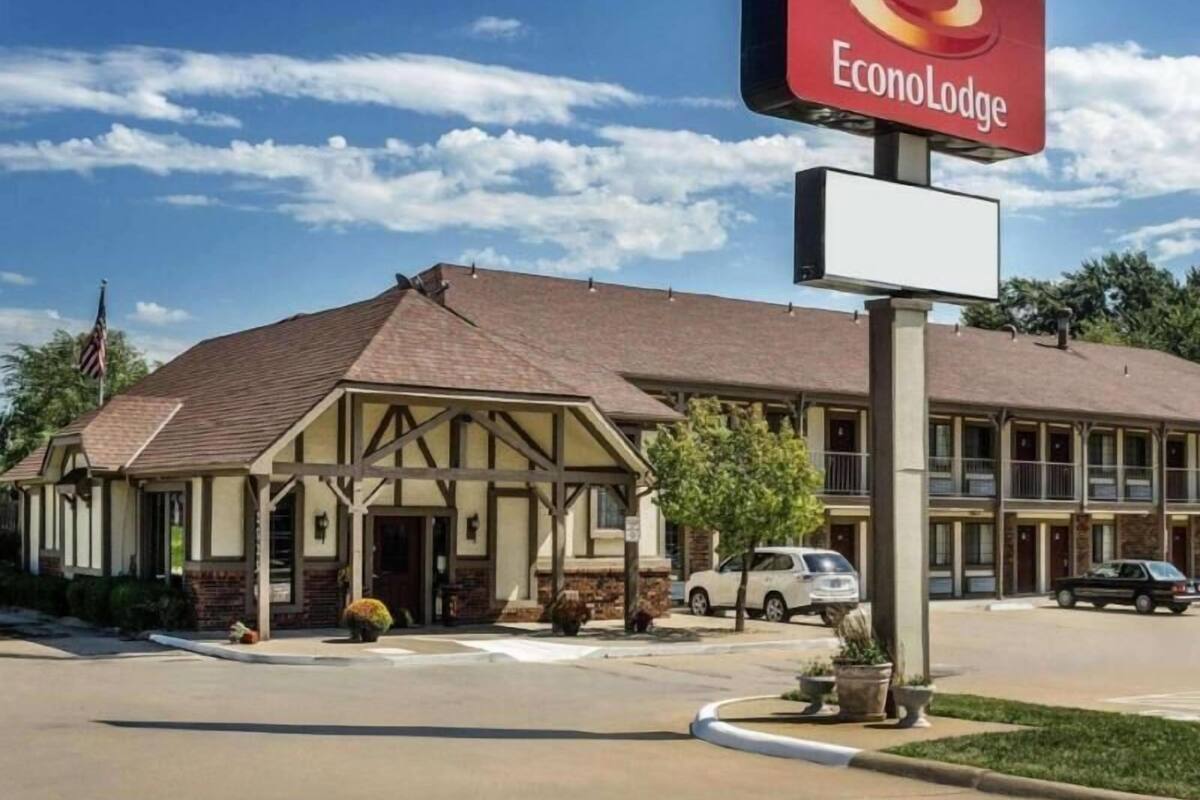 A two-story EconoLodge building with a traditional architectural style, featuring a prominent red and yellow sign.
