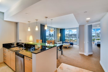 Enjoy a spacious room with a large kitchen, dining area, and seating space, offering a city view. at Marenas Beach Resort