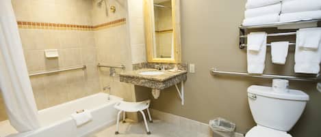 A bathroom with a bathtub, toilet, sink, and a towel rack.