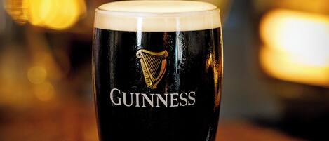 A Guinness glass on a coaster.