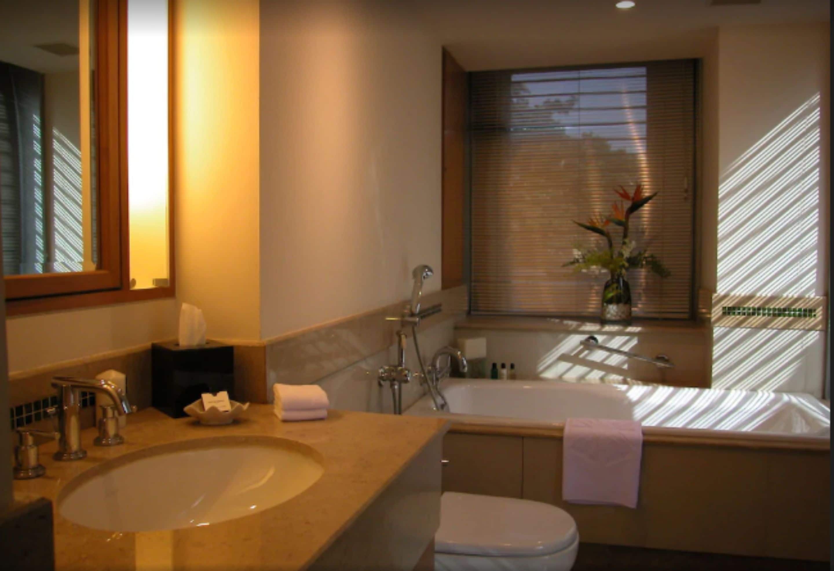 A bathroom with a sink, toilet, and bathtub.