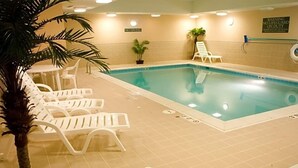 An indoor swimming pool with white lounge chairs and a 'NO DIVING' sign. - Sorell Hotel Asora (Arosa)