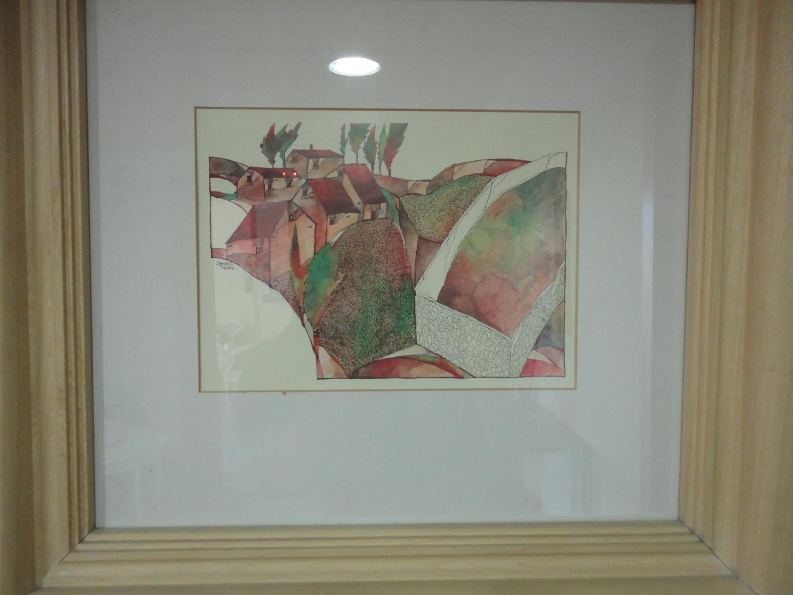 Un cuadro abstracto enmarcado con formas geométricas y colores suaves.