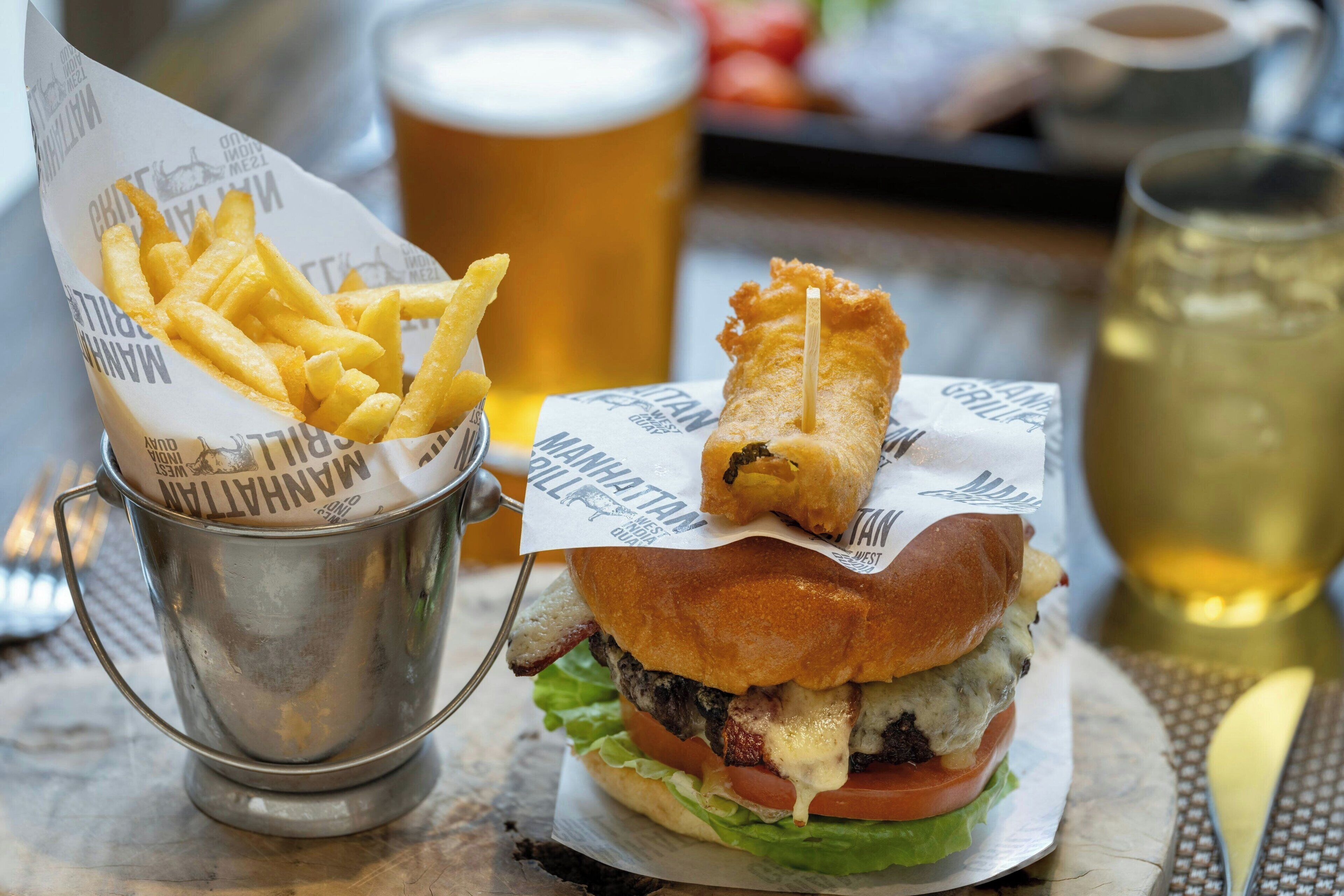A meal with a burger, fries, and a drink.