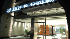 The entrance to a hotel named 'Ayres de Recoleta' with a modern design, featuring a reception area with seating and a glass door entrance. - Ayres Apartments Recoleta - Uriburu (Buenos Aires)