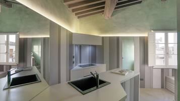 A modern kitchen with a built-in stove, a sink, and a window.