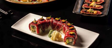 A plate of sushi with a variety of toppings and garnishes.