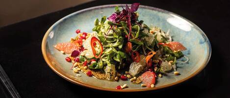 A plate of food with various ingredients and garnishes.