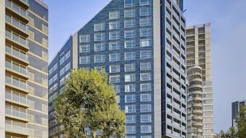 Stunning high-rise building with a sleek glass facade and central entrance.