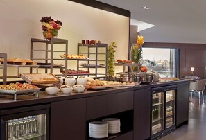 A buffet setup with various food items and beverages, including fruits, pastries, and drinks. - Park Plaza London Riverbank (London)