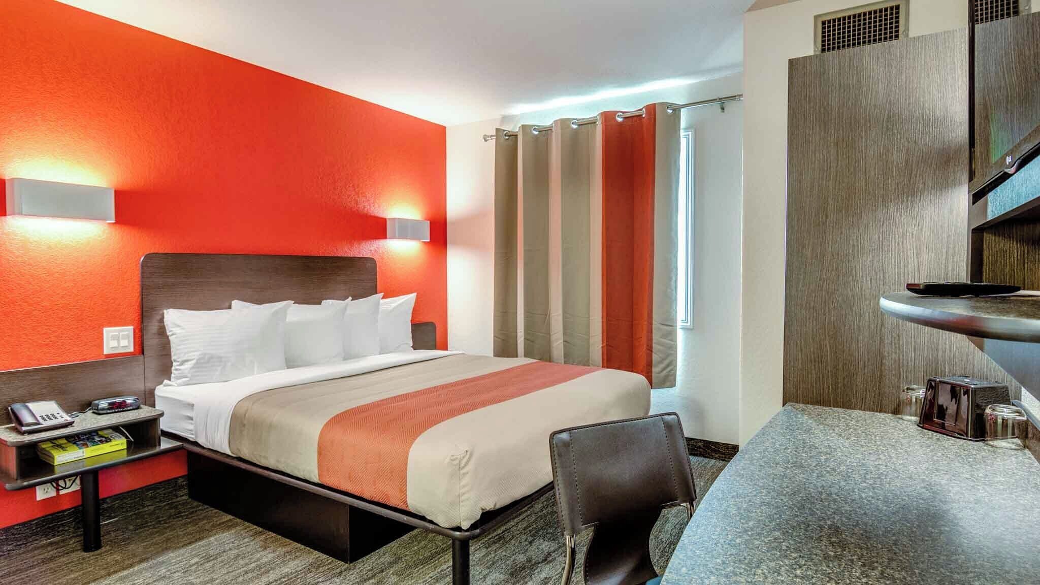 Desk, laptop workspace, blackout drapes, iron/ironing board