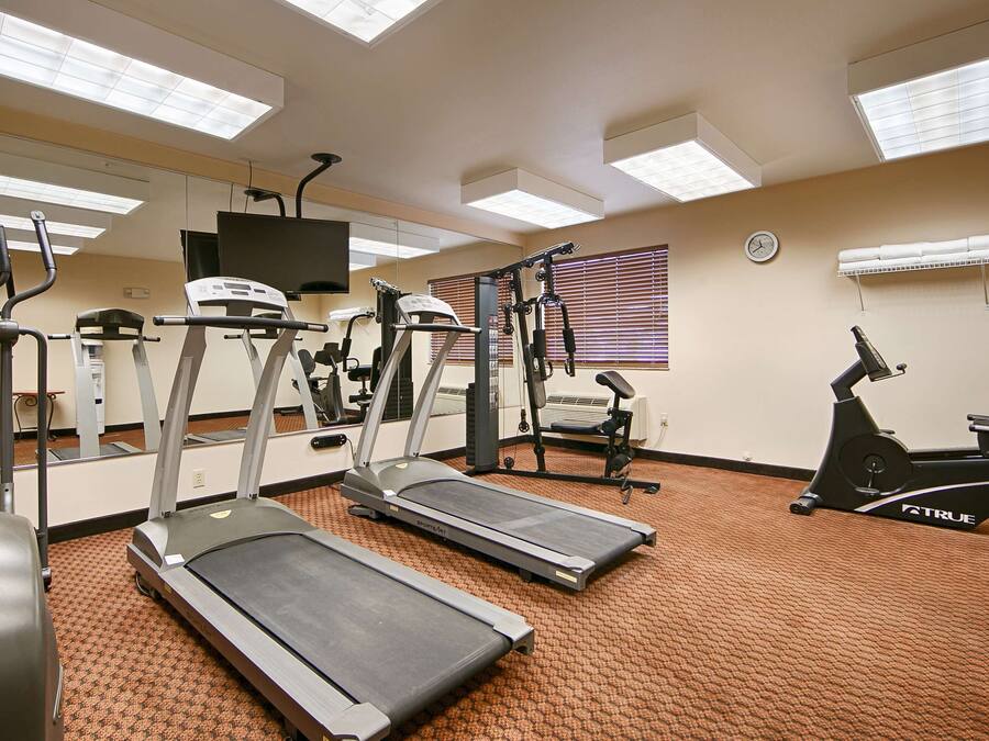 A fitness center with treadmills, elliptical machines, and a stationary bike.