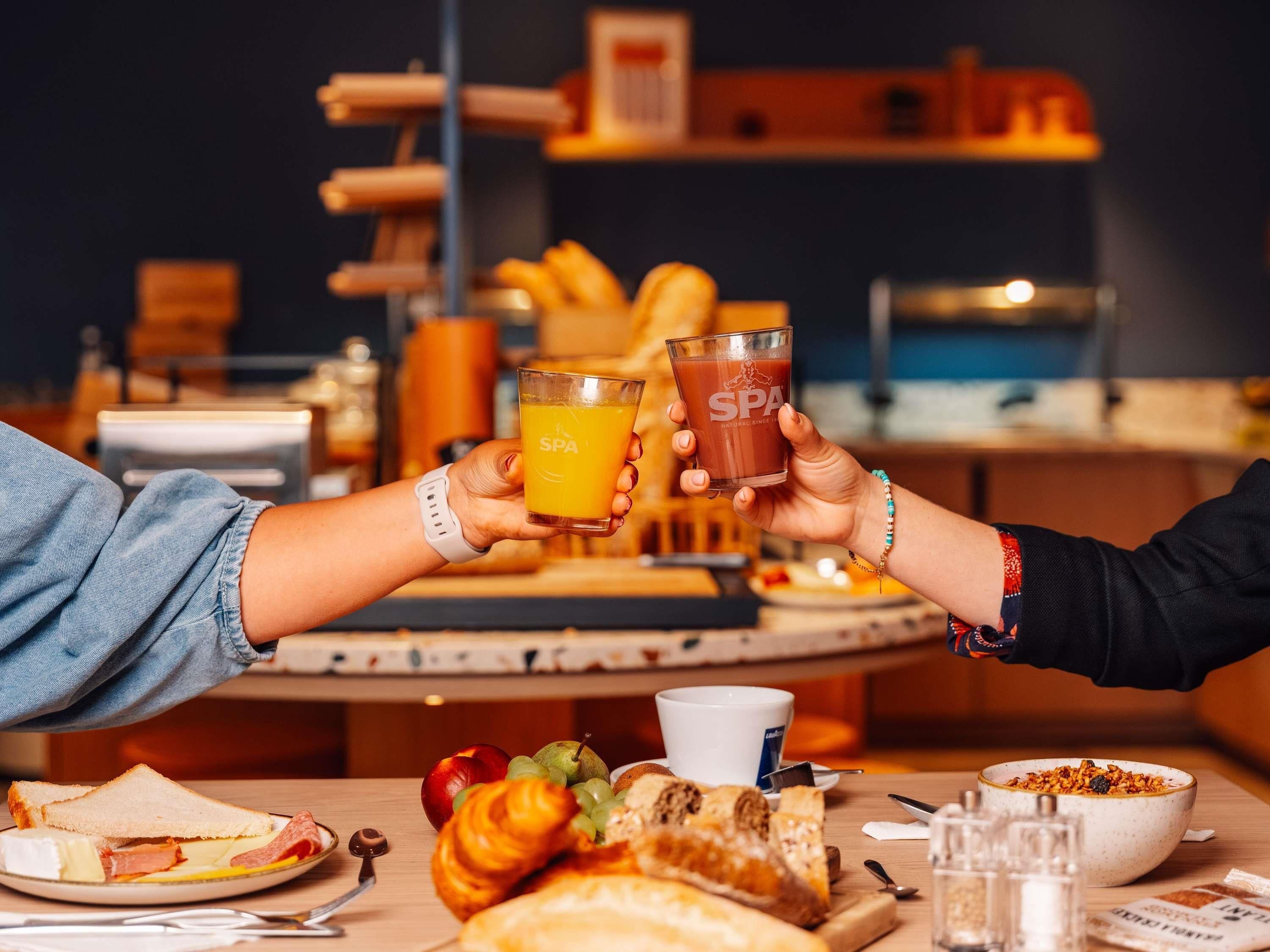 A breakfast setting with toast, fruit, and a bowl of cereal.