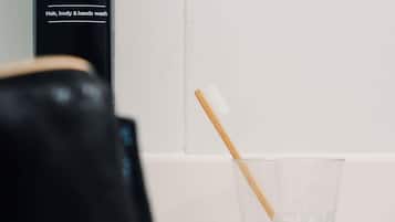A bathroom with a glass of water and a toothbrush.