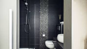 A modern bathroom with a shower, toilet, and sink.